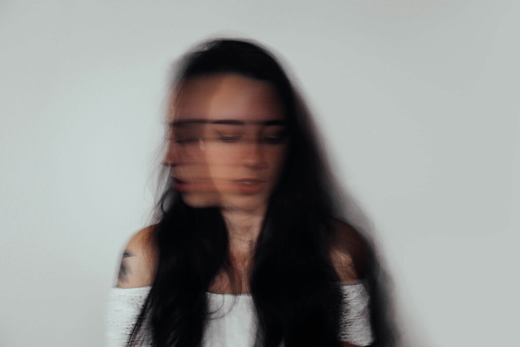 A blurry image of a young woman shaking her head in a fast motion. With anxiety therapy in NYC, NY, you can learn different strategies to help manage anxiety. Start working with an NYC anxiety therapist today. 