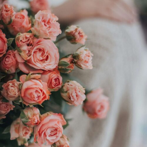 A woman holding a bouquet of pink roses. Anxiety counseling in NYC, NY can help you improve your well-being. Begin working with an anxiety therapist today.