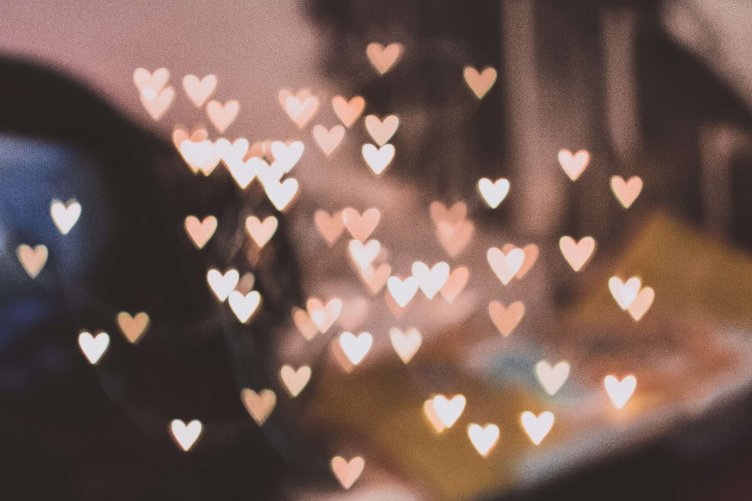 A picture of blurry lights shaped into hearts. If you struggle with anxiety, learn how self-compassion can help alleviate those feelings. Learn more in NYC anxiety counseling.