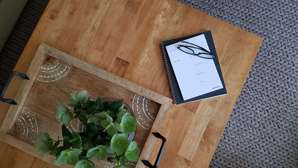 A table with a few journals and calendar sitting on it along with glasses. Did you know we offer anxiety counseling in NYC, NY to help with work anxiety? Call today to get started!