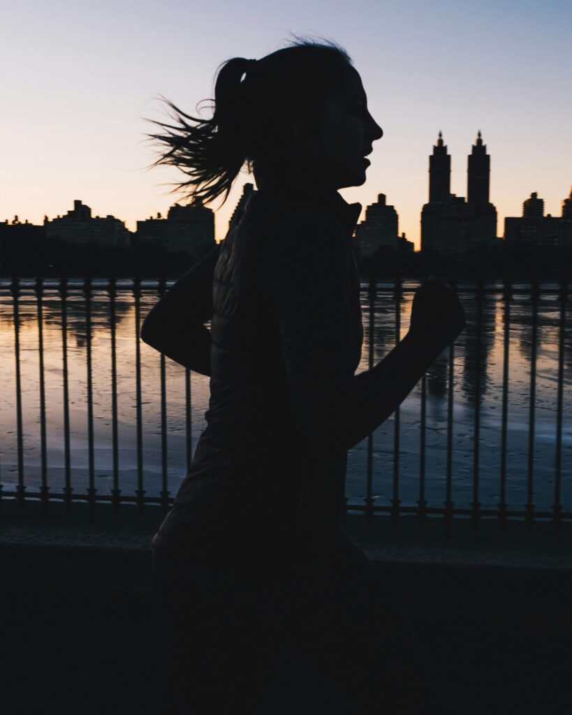 A woman running in New York City during sunset. With anxiety counseling in NYC, NY, you & a therapist will work to find coping strategies for when feelings arise. Call us today to start!