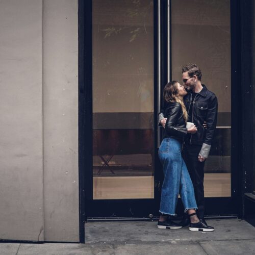 A couple standing next to each other while outside of a tall building. As an anxiety therapist in NYC, I can help you overcome ROCD & anxious attachment. Learn more here!