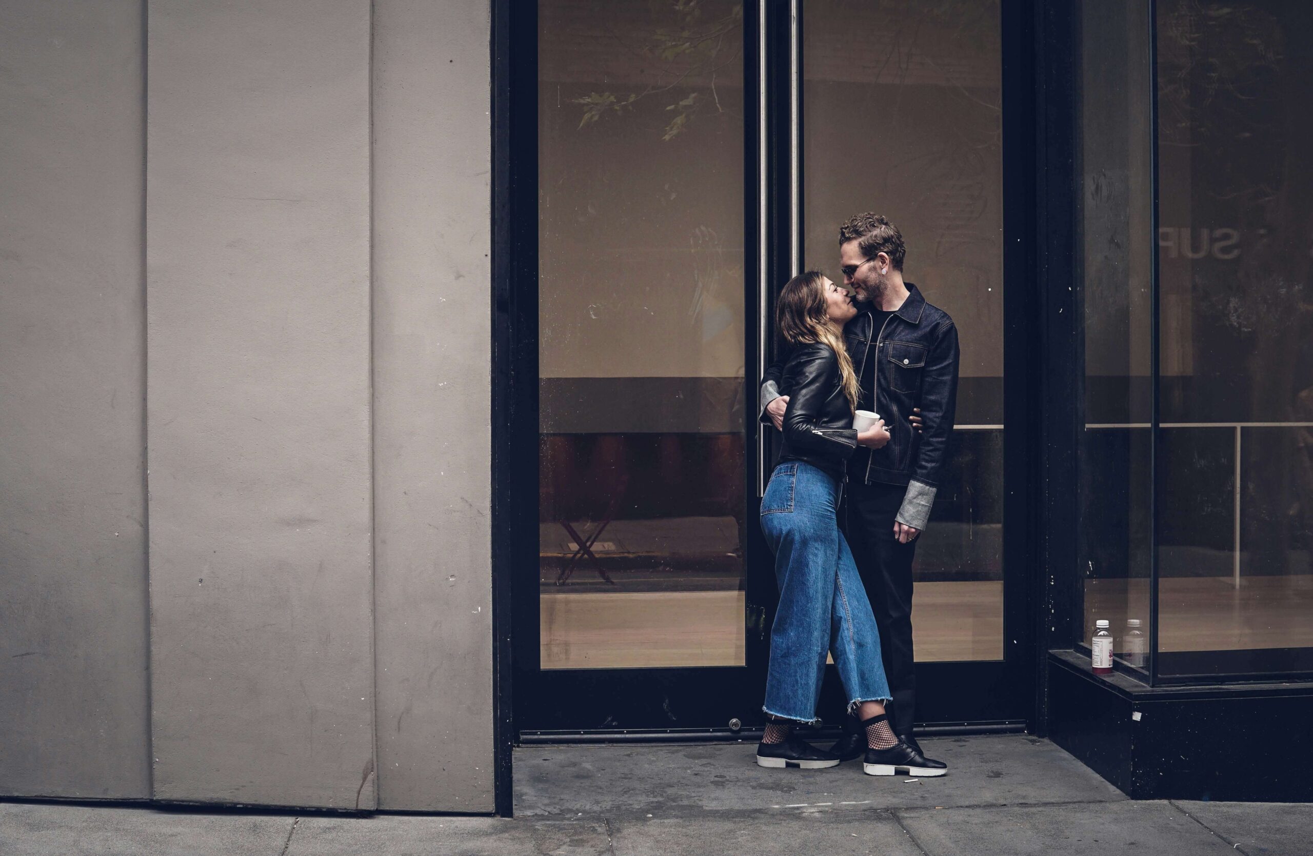 A couple standing next to each other while outside of a tall building. As an anxiety therapist in NYC, I can help you overcome ROCD & anxious attachment. Learn more here!