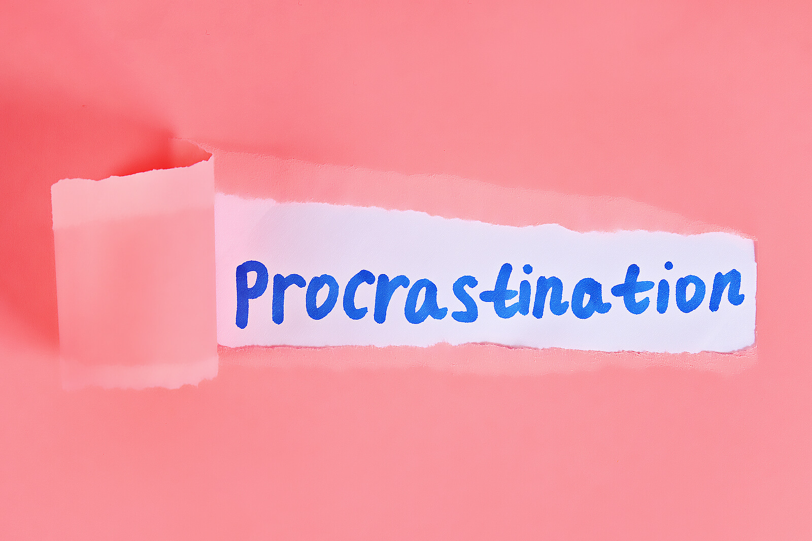 A pink piece of paper being ripped & revealing the word "procrastination" in marker. Anxiety counseling in NYC, NY can help you find balance in your life. Don't let anxiety & procrastination hold you back any longer!