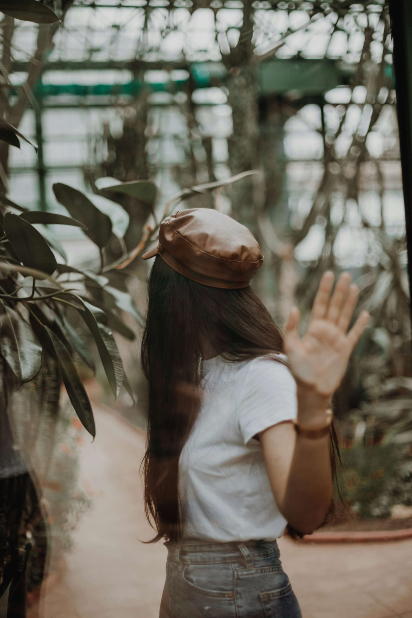 A woman with long brown hair holding her hand to the camera & looking away. Learn why anxiety therapy in NYC, NY can help anxious women thrive. Start your healing journey today with an anxiety therapist.