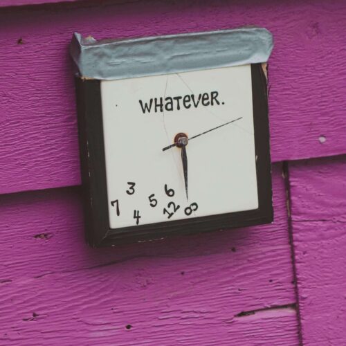 A square clock that says "whatever" & the numbers have fallen to the bottom. This represents how procrastination can create more anxiety when feeling like your to-do list isn't finished. Work with an anxiety therapist in NYC, NY today to help.