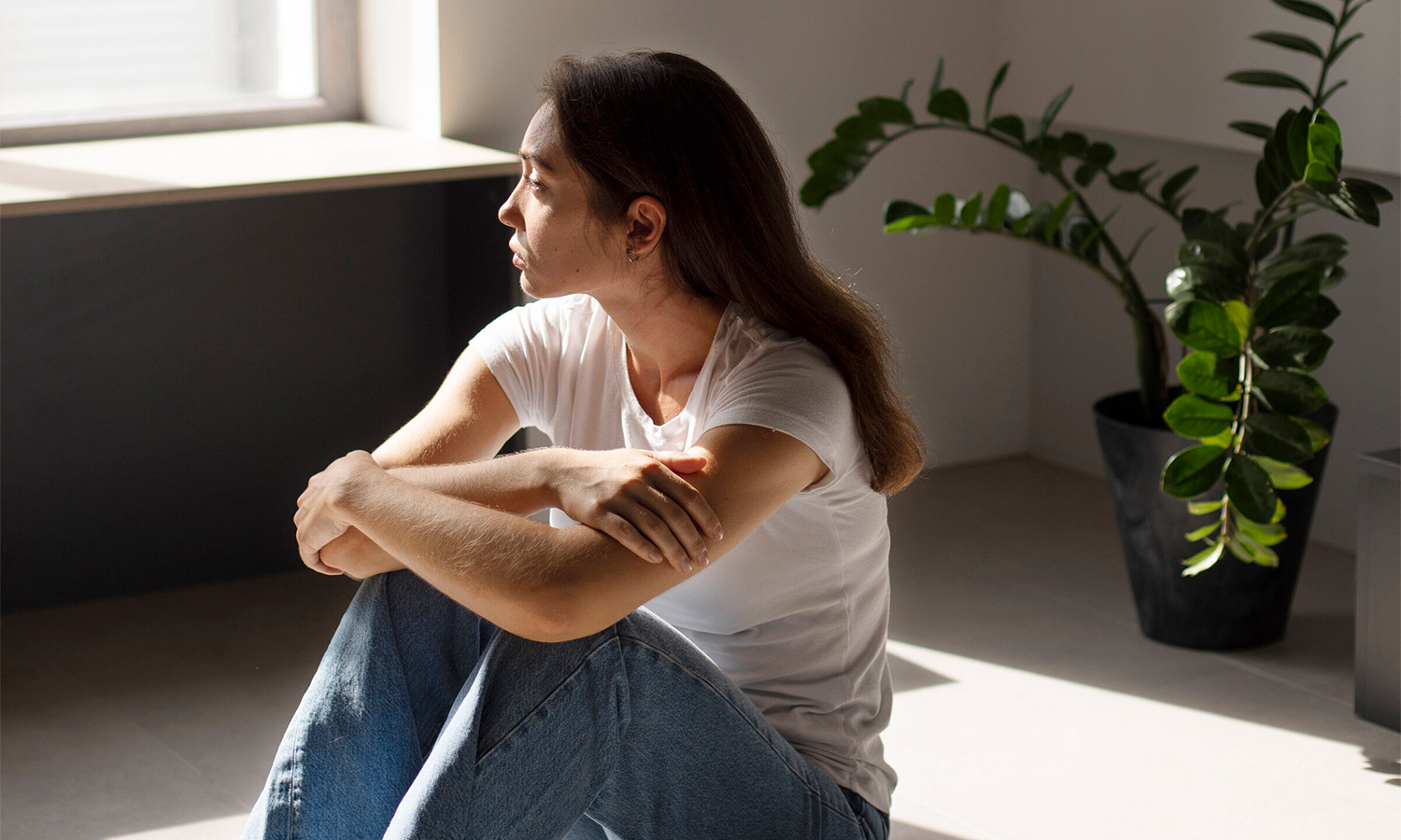 portrait-young-woman-with-low-self-esteem-sitting-by-window-home