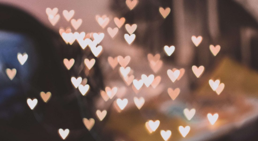 A picture of blurry lights shaped into hearts. If you struggle with anxiety, learn how self-compassion can help alleviate those feelings. Learn more in NYC anxiety counseling.