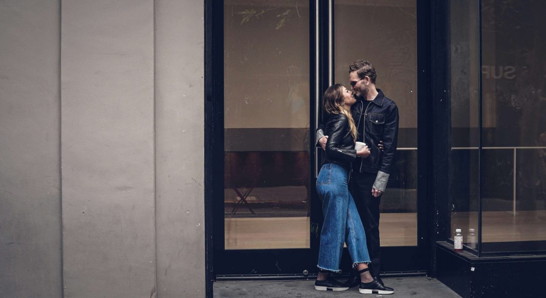 A couple standing next to each other while outside of a tall building. As an anxiety therapist in NYC, I can help you overcome ROCD & anxious attachment. Learn more here!